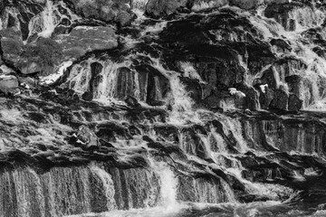 Fototapeta premium Der Wasserfall Hraunfossar des Flusses Hvita nahe Reykolt. / The waterfall Hraunfossar of the river Hvita near Reykolt.