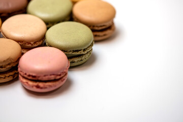 several multi-colored macaroon cakes on a white background
