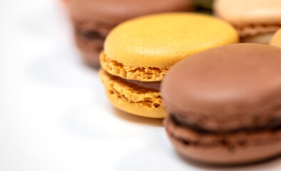 several multi-colored macaroon cakes on a white background