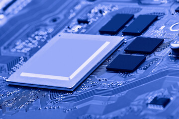 Electronic circuit board with electronic components such as chips close up. Blurry background.	