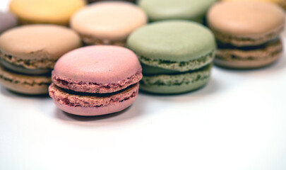 several multi-colored macaroon cakes on a white background
