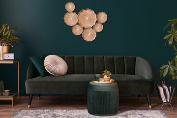 Luxury living room in house with modern interior design, green velvet sofa, coffee table, pouf, gold decoration, plant, lamp, carpet, pillows and elegant accessories. Template.