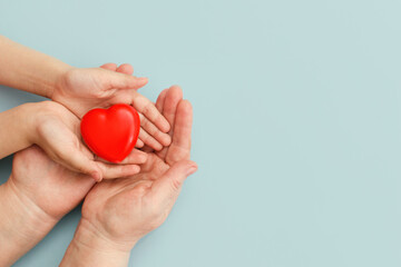 Concept Happy Mother's Day or International Day of Families.Happy women's day.Heart in the hands of daughter and mother on a blue background.I love you.Banner for store.Greeting card.Copy space.banner