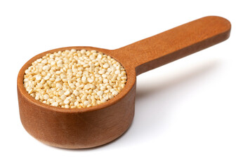 Fototapeta na wymiar raw white quinoa seeds, in the wooden measuring spoon, isolated on pure white background