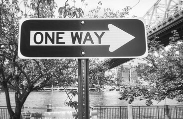 Black and white picture of One Way street sign in Roosevelt Island, New York City, USA.