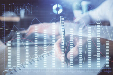 Double exposure of forex chart drawing over people taking notes background. Concept of financial analysis