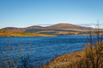 Clatteringshaws Loch on a sunny winters day, in Southern Scotland.