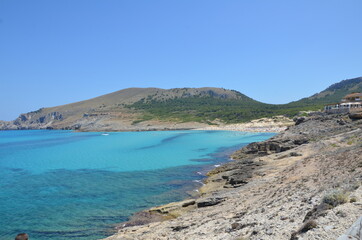 A wonderful view of the sea coast. Sea water against the background of the mountain, which glows in the rays of the summer sun. A magical summer.
