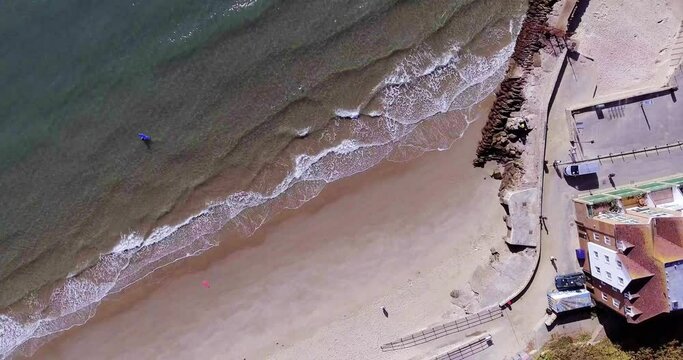 Aerial View of waves on the shore at Sunny Sands, Folkestone Kent