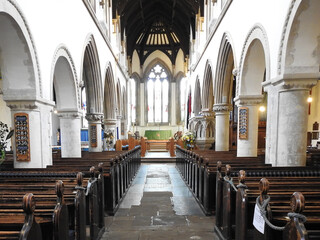 Long church interior with pews and columns