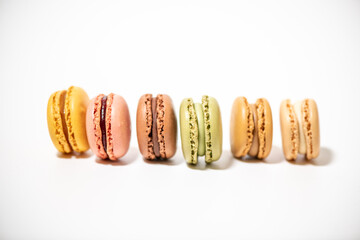 several multi-colored macaroon cakes on a white background