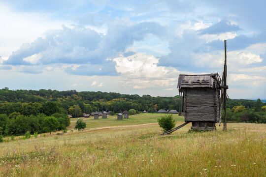 Summer landscape with an old wooden mill