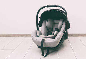 Empty baby car seat on the floor in the house