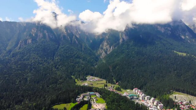 The Bucegi mountains are rock formations and forest. The top is covered with white clouds. The beautiful nature scenic took with drone aerial 4K 30fps.