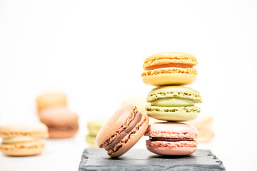 several multi-colored macaroon cakes on a white background