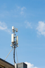 5g and 4g antenna on the roof of a residential building, Milan, Italy. Blue sky on the background