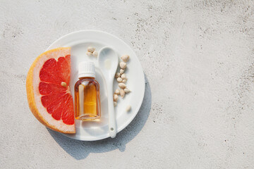 Bottle with grapefruit seed oil extract, piece of grapefruit, seeds. Medicines for treatment of covid, natural antibiotic, antiviral drug. Immunity boosting with citrus fruit, vitamin C, Coronavirus