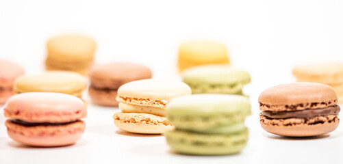 several multi-colored macaroon cakes on a white background
