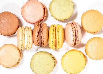 several multi-colored macaroon cakes on a white background