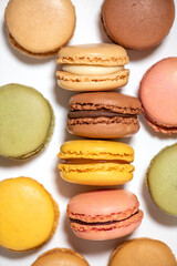 several multi-colored macaroon cakes on a white background