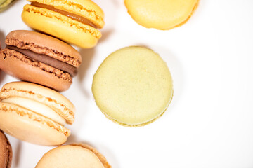 several multi-colored macaroon cakes on a white background