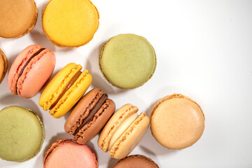 several multi-colored macaroon cakes on a white background