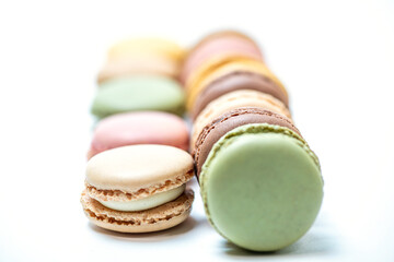 several multi-colored macaroon cakes on a white background