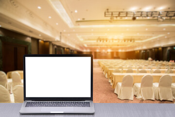 Laptop on desk in empty seminar room or classroom or meeting room with row of chairs
