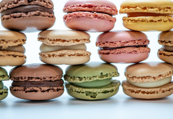 several multi-colored macaroon cakes on a white background