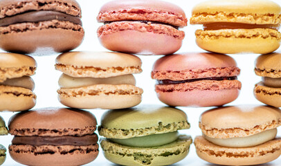 several multi-colored macaroon cakes on a white background