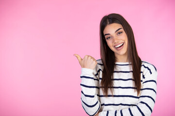 Dreamy and pleased young attractive woman found exactly what need, look and pointing left satisfied with delighted happy smile observe something cool, recommend product, pink background