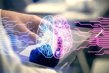 Double exposure of man's hand holding and using a digital device and brain hologram drawing. Data...