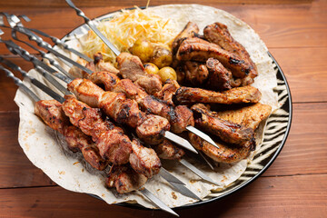 Roasted lamb ribs with sauce on wooden background,