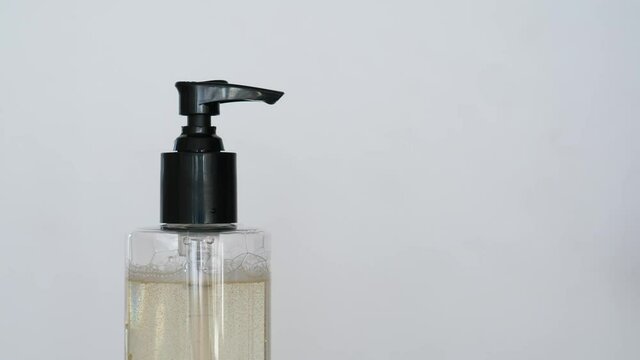 Man squeeze liquid soap on arm and rub hands, washing routine, healthy habits concept. Closeup shot of dispenser bottle with typical cleaning gel. Personal hygiene in regular life