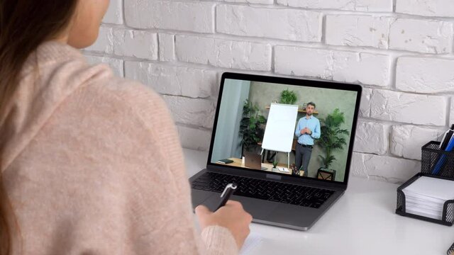 Woman at home study watch online remote business webinar master class course webcam laptop, writes in notebook listen teacher. Distance coach near whiteboard in computer screen teaches tells student