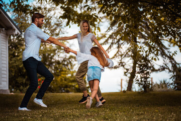 Happy family playing in backyard.