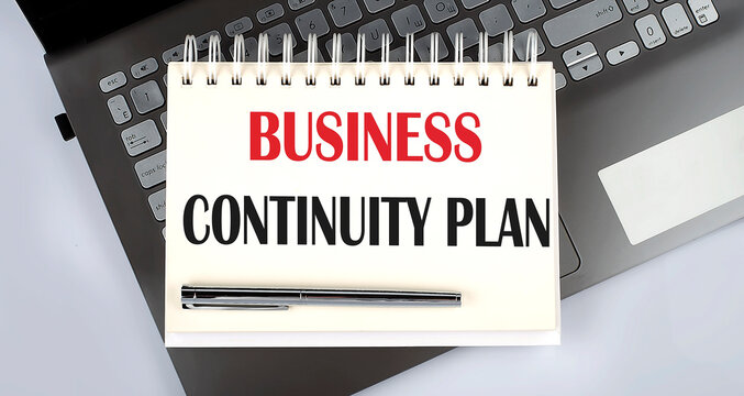 Business continuity Plan - Top view notebook writing on the laptop