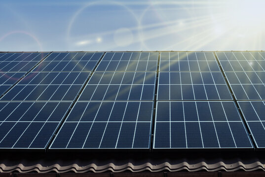 Solar panel with sunlight and blue sky background. concept clean energy power in nature.