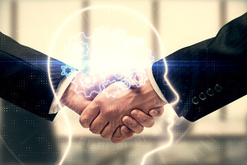 Double exposure of brain hologram and handshake of two men. Partnership in IT industry concept.