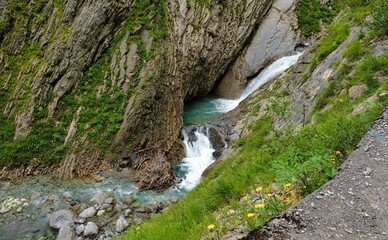 valley with river waterfall and trees in open nature