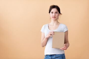 smiling blonde girl shows a box.