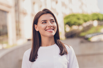 Fototapeta premium Photo of optimistic brunette lady look wear white t-shirt walking in park outside