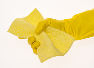 Yellow sponge for washing and cleaning in a woman's hand. Hand in latex glove isolated on white. A hand in a glove holds a napkin