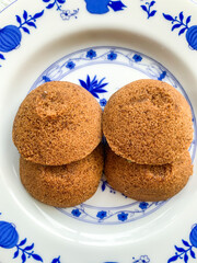 Putu Cangkir is a traditional snack from Makassar, South Sulawesi, Indonesia. Made from sticky rice, brown sugar, filled with grated coconut and covered with pandan leaves.