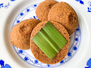 Putu Cangkir is a traditional snack from Makassar, South Sulawesi, Indonesia. Made from sticky rice, brown sugar, filled with grated coconut and covered with pandan leaves.