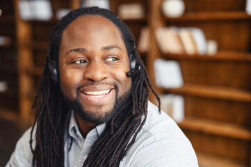Close-up of mature black african man with dreadlocks, operator of call center or business leader....