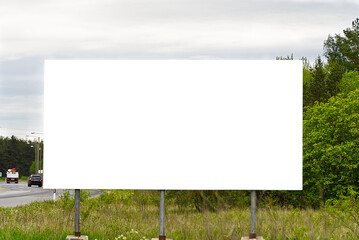 Empty white Billboard on a background of green nature. Suitable for advertising. Blank billboard and outdoor advertising. Mockup - obrazy, fototapety, plakaty