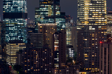 Fototapeta na wymiar Tokyo City lights night scene. The night lightings of skyscrapers at Shiodome, Minato Ward. Tokyo. Japan