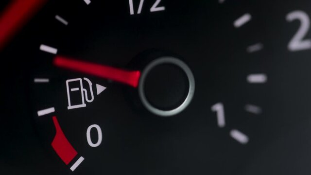 Fuel Gauge Car Dashboard Fills up. Red Light Turn On When Tank is Full or Vehicle Activated. Close Up petrol meter on black background