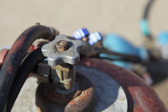 Propane tank valve on hose and Gas burner background closeup , metal cutting